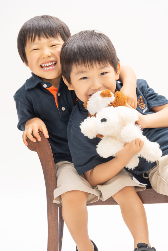 Children laughing during indoor family photoshoot Singapore
